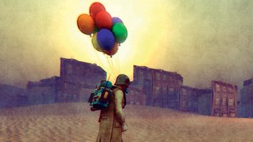 Soldier with colorful balloons in desert